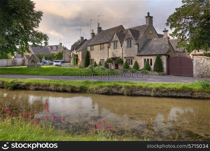 Pretty Cotswold cottages at the popular tourist destination of Lower Slaughter near Bourton on the Water, Gloucestershire, England.