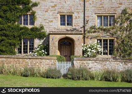 Pretty Cotswold stone farmhouse, Gloucestershire, England.