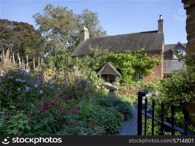 Pretty cottage with garden full of flowers, Warwickshire, England.