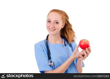 Pretty doctor in blue uniform with stethoscope and apple isolated on white