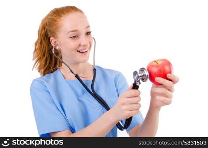Pretty doctor in blue uniform with stetothcope and apple isolated on white