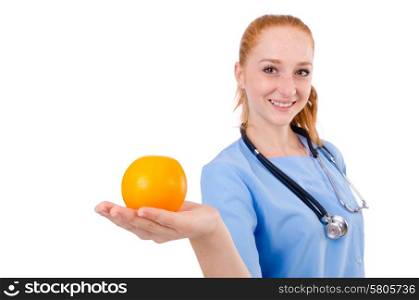 Pretty doctor in blue uniform with stetothcope and orange isolated on white