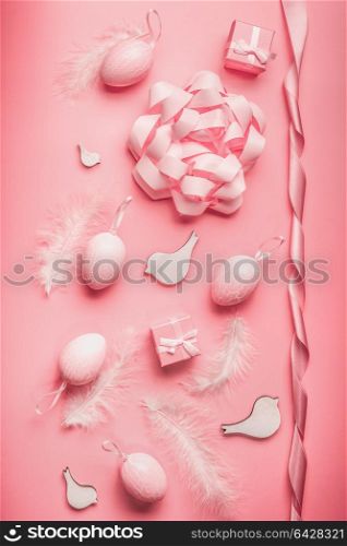 Pretty Easter pink composing with eggs,ribbon,bow, birds and feather on table background, top view, flat lay