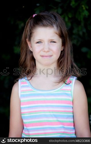 Pretty eight year old girl with blue eyes in the park