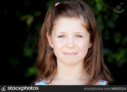 Pretty eight year old girl with blue eyes in the park