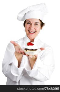 Pretty female pastry chef holding a delicious cheesecake tart topped with strawberry and chocolate. Isolated on white.