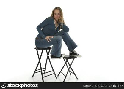 Pretty female teen posing and sitting on a stool. Shot with Canon 20D.