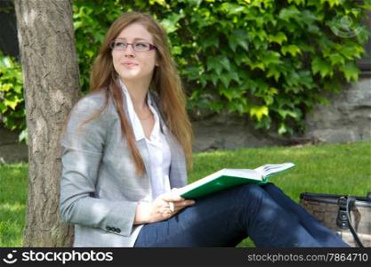 Pretty female universtity student studying outdoor