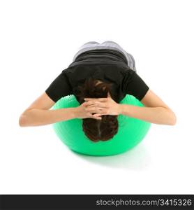 Pretty fit woman training with a pilates ball, isolated over a white background