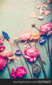 Pretty flowers retro pastel toned on vintage turquoise background, top view