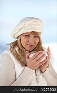 pretty girl drinking tea by wintry day