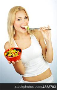 Pretty girl eating fruit salad, healthy fresh breakfast, dieting and health care concept