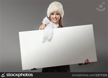 Pretty girl holding a white message board