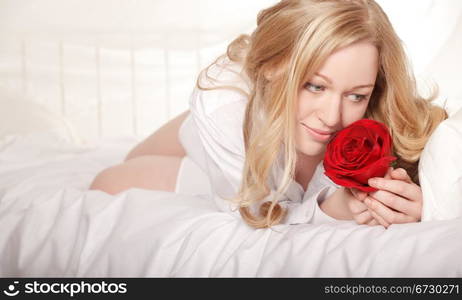 pretty girl in bed with red rose