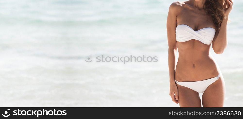 Pretty girl in bikini with perfect body at tropical sea beach. Pretty girl at the beach