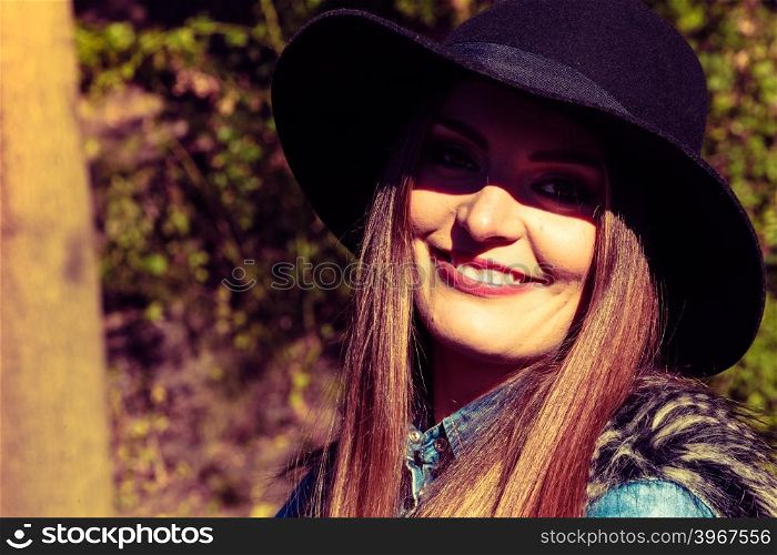 Pretty girl in park. Fashion and style of female. Attractive and fashionable woman outdoor. Portrait of charming young lady resting on air in park.