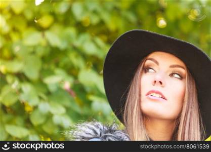 Pretty girl in park. Fashion and style of female. Attractive and fashionable woman outdoor. Portrait of charming young lady resting on air in park.