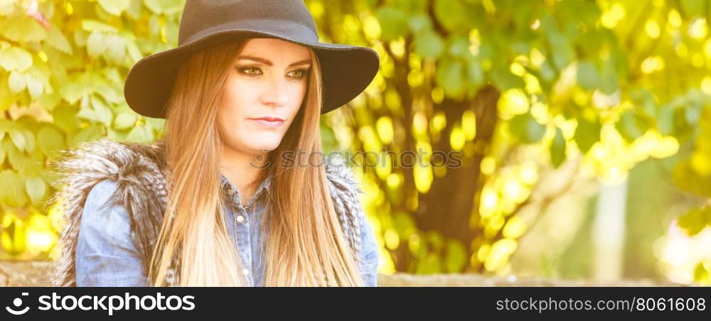 Pretty girl in park. Fashion and style of female. Attractive and fashionable woman outdoor. Portrait of charming young lady resting on air in park.