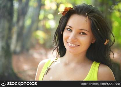 Pretty girl in the autumn forest with yellow leaves