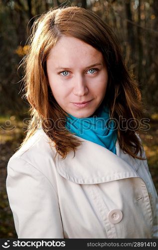Pretty girl in white cloak on forest background