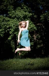 Pretty Girl Jumping High On The Nature Background