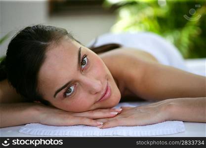 Pretty girl lying on massage table