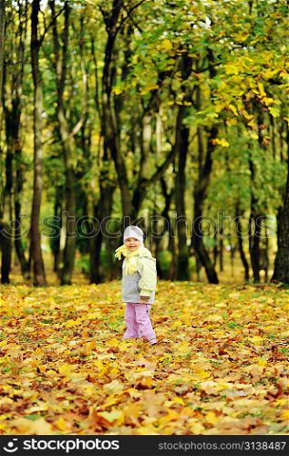 pretty girl playing in autumn park