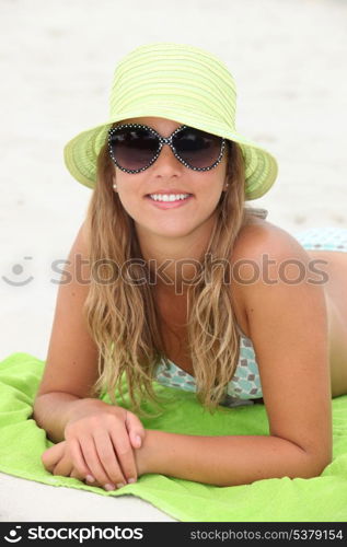 Pretty girl suntanning at the beach