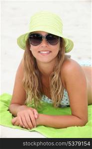Pretty girl suntanning at the beach