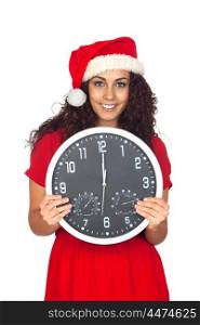 Pretty girl with christmas hat and a clock with twelve o'clock