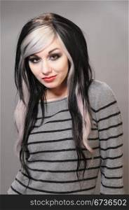 Pretty girl with goth hair in a striped sweater