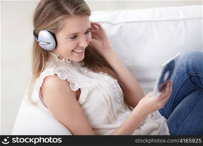 Pretty girl with headphones music CDs at home