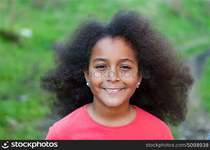 Pretty girl with long afro hair in the garden
