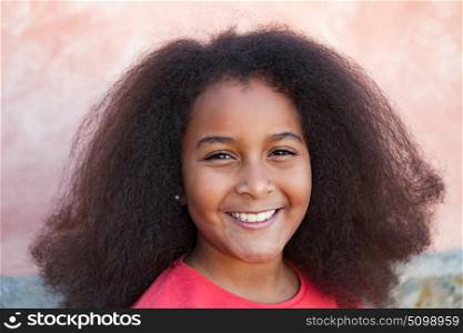 Pretty girl with long afro hair in the garden laughing