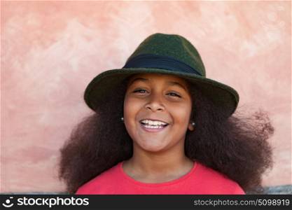Pretty girl with long afro hair in the garden with a elegant black hat