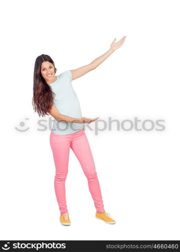 Pretty girl with pink pants showing something with her arms isolated on white