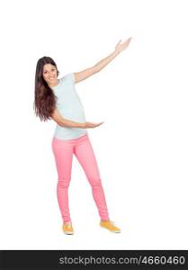 Pretty girl with pink pants showing something with her arms isolated on white