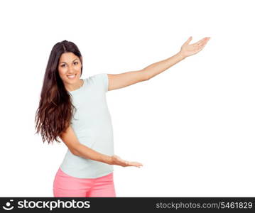 Pretty girl with pink pants showing something with her arms isolated on white