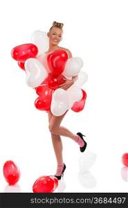 pretty girl with red and white balloons on her body, she is turned of three quarters at right, looks in to the lens and her left leg is raised