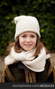 Pretty girl with wool hat in a park at winter
