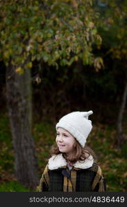 Pretty girl with wool hat in a park at winter