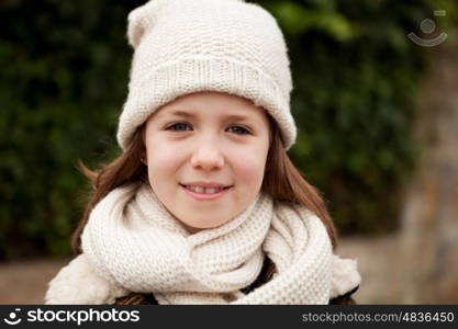 Pretty girl with wool hat in a park at winter