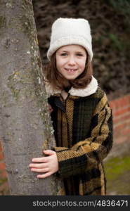 Pretty girl with wool hat in a park at winter