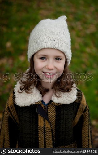 Pretty girl with wool hat in a park at winter