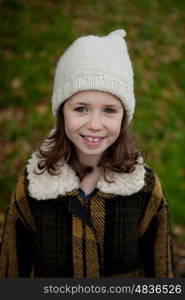 Pretty girl with wool hat in a park at winter