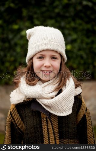 Pretty girl with wool hat in a park at winter