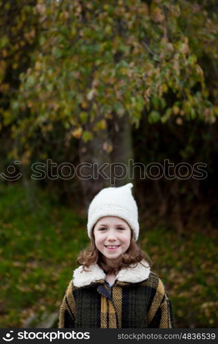 Pretty girl with wool hat in a park at winter