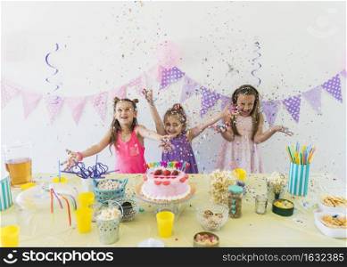 pretty girls enjoying birthday party home with variety food juice table