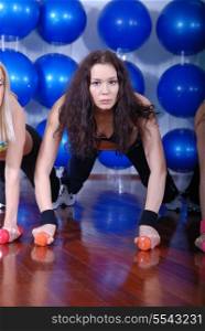 pretty girls working out in a fitness club