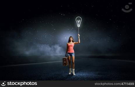 Pretty hitchhiking girl. Young retro woman with balloon and her retro baggage in hand